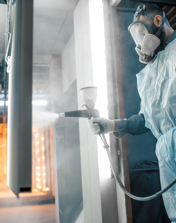 Technician using powder coating process