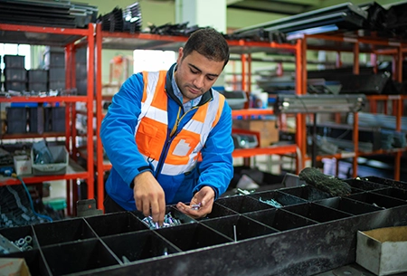 Warehouse male worker examining goods in factory