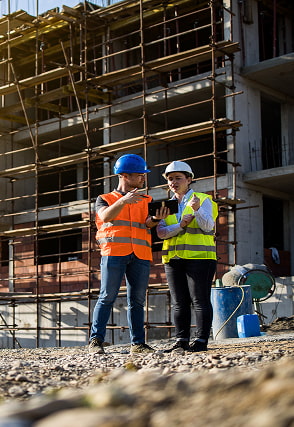 Two construction workers talking onsite